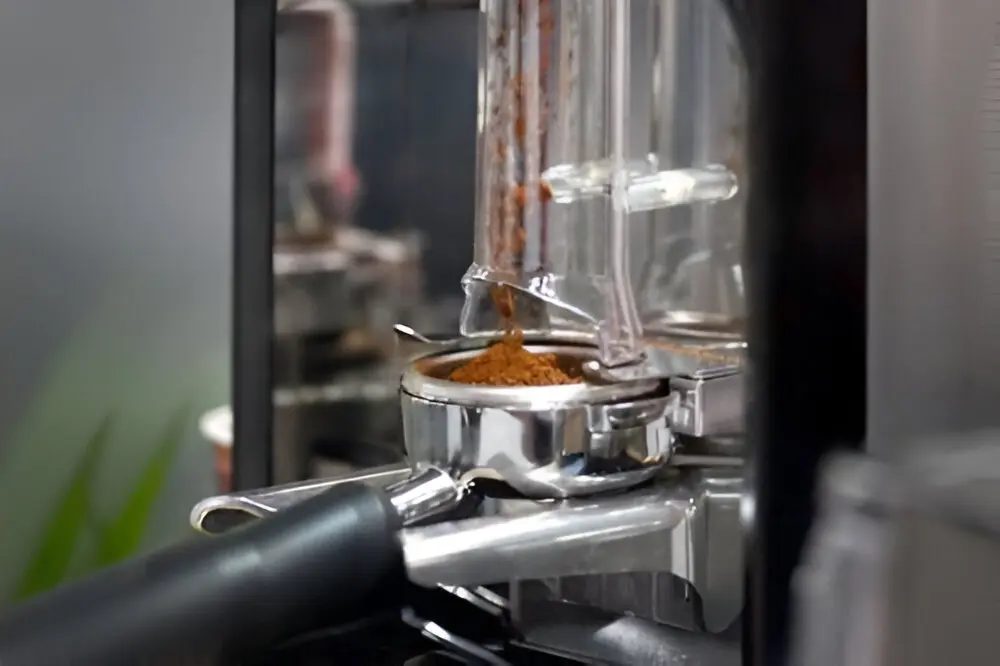 A close up of an espresso machine with the pot in it