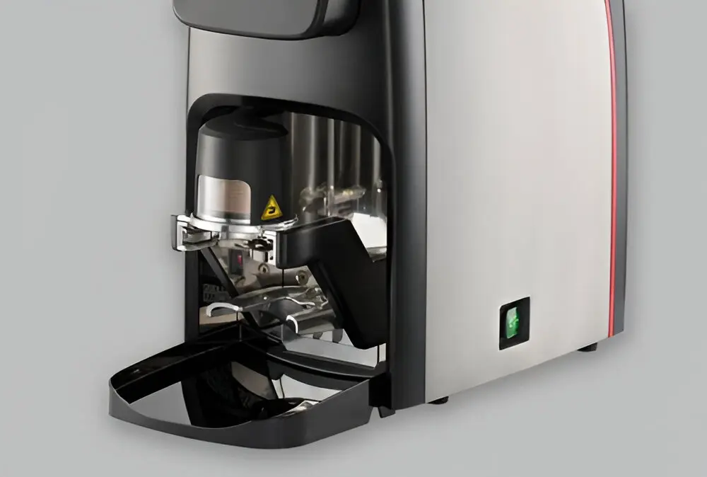 A close up of the bottom part of an espresso machine.